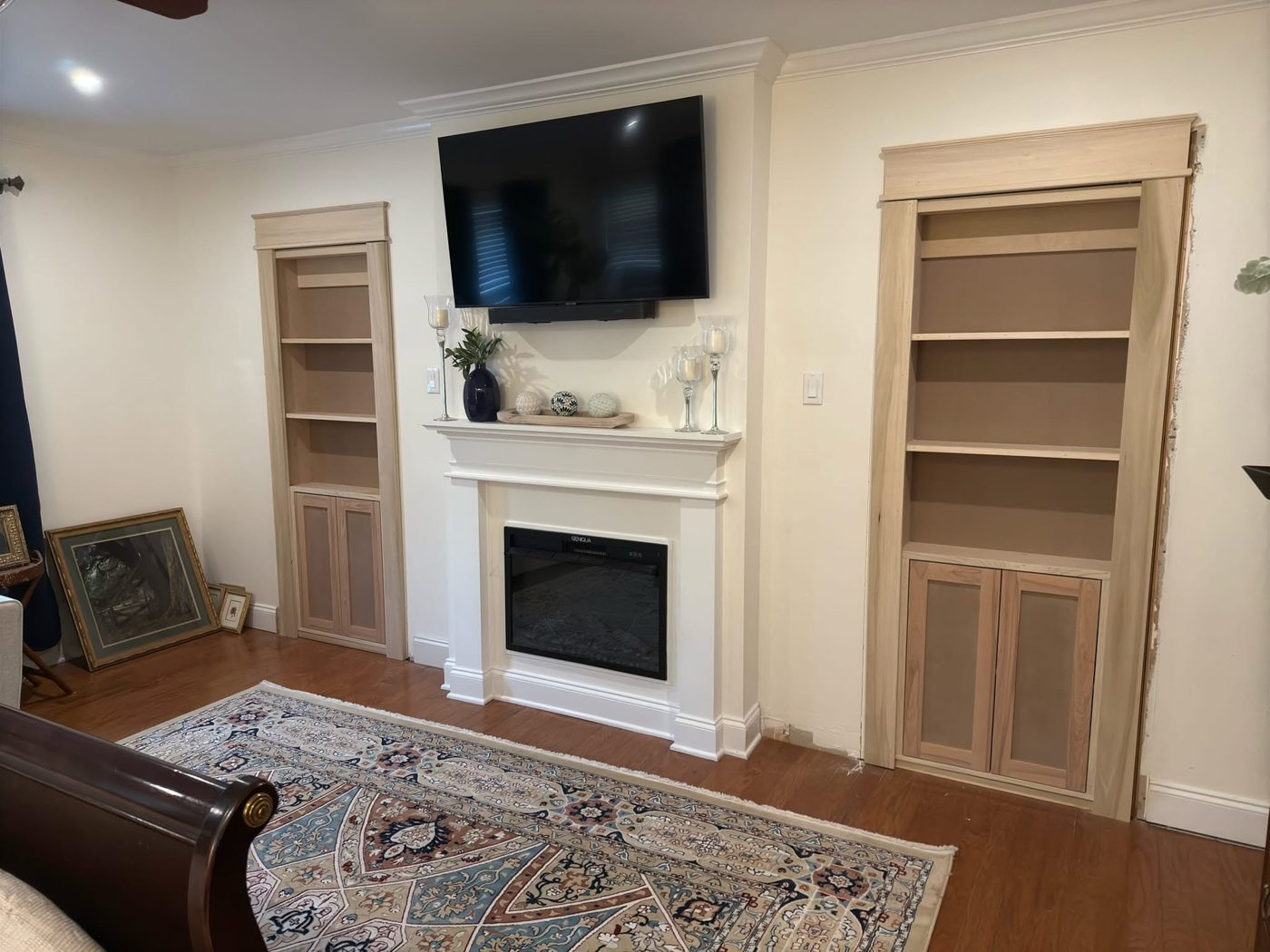 Built-in bookcases on both sides of a fireplace, built by Father and Sons Custom Woodworks